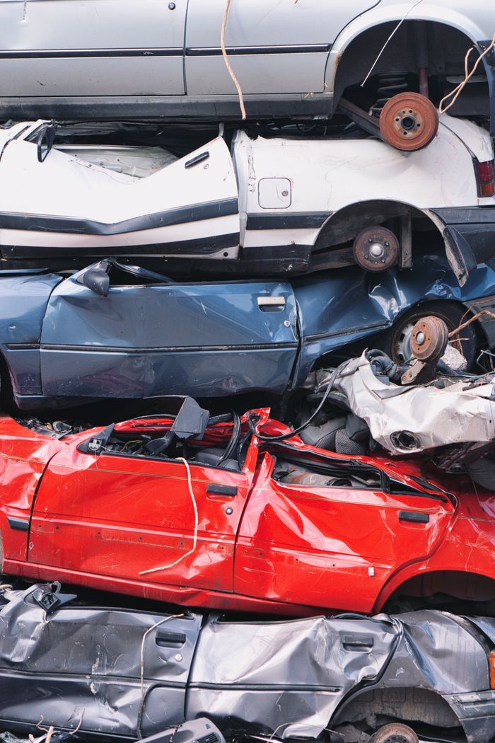 About Vertical shot of crushed cars stacked at a junkyard in Bern, Switzerland.